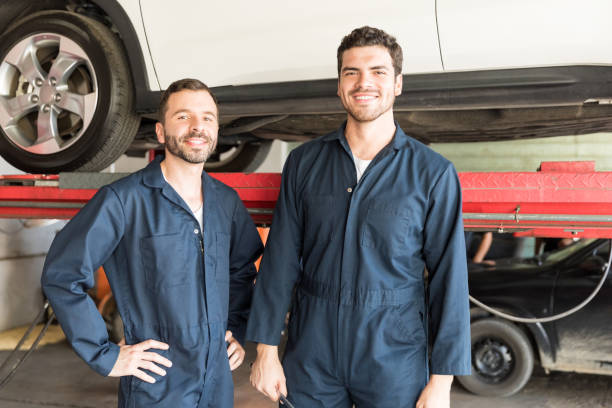 istock Mechanics Smiling In Auto Repair Shop 1006971702