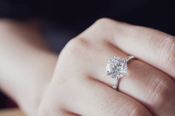 istock engagement diamond ring on woman finger closeup 1006983812