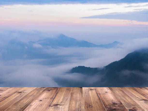 istock Wood table top over soft foggy on mountain 1006984122