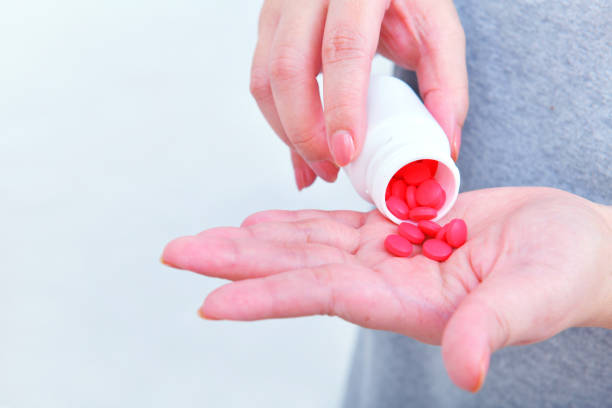 istock Holding medicine bottle and pour in hand 1007027666