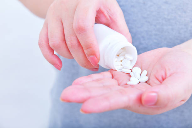 istock Holding medicine bottle and pour in hand 1007027710