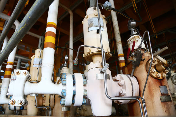istock Wellhead on the remote platform and controlled by PLC program to open and close for production oil and gas, Wellhead control panel under operation and maintenance by technician. 1007038750