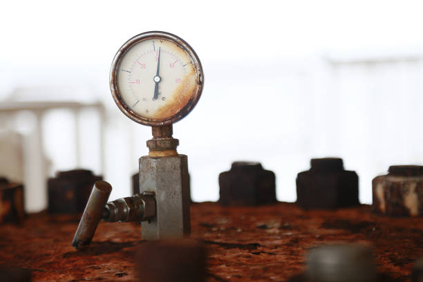 Pressure gauge using measure the pressure in production process. Worker or Operator monitoring oil and gas process by the gauge for routine record and analysis oil and gas production process.