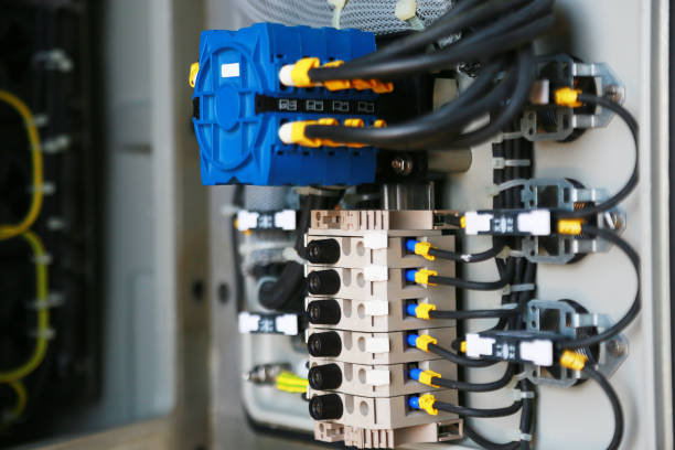 istock Electrical terminal in junction box and service by technician. Electrical device install in control panel for support program and control function by PLC. routine visit check equipment by technician. 1007046484