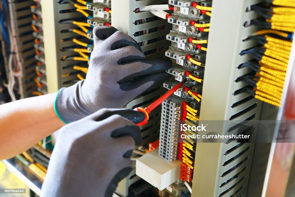 Electrical terminal in junction box and service by technician. Electrical device install in control panel for support program and control function by PLC. routine visit check equipment by technician. Electricity Stock Photo