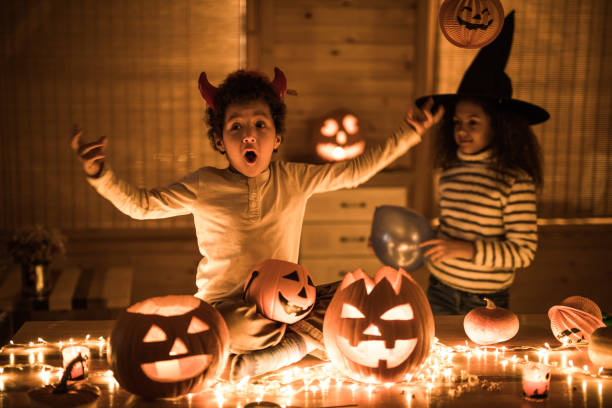 istock Two black siblings having fun on Halloween at home. 1007047128