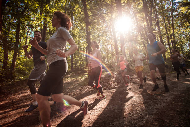 istock Group of athletes talking while running a marathon in the forest. 1007049920