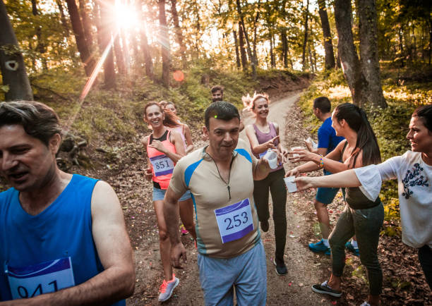 istock Group of athletes refreshing themselves with water during marathon race. 1007050144