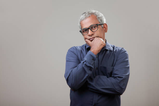 istock Middle aged man of Indian origin with a thinking face 1007053032