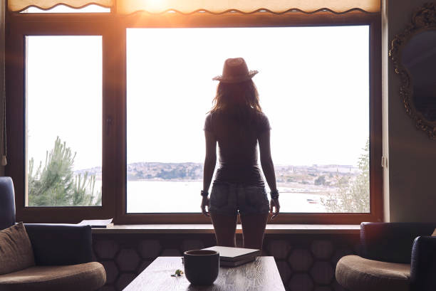 istock Woman getting away from it all in hotel lobby 1007059162