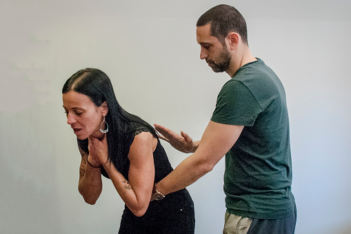 guy making the Heimlich maneuver to a girl while she's choking