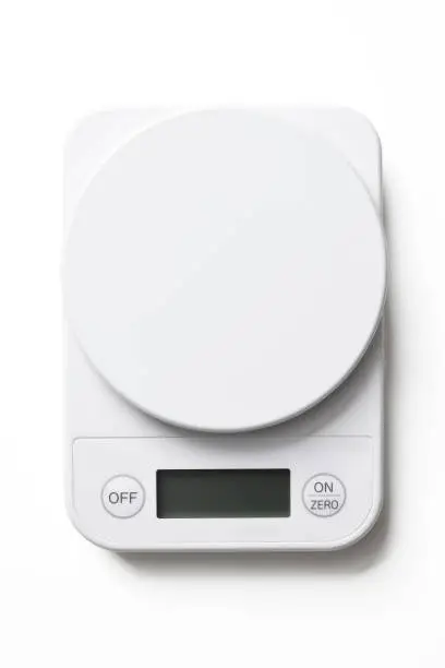 Close-up of kitchen digital food weight scale, isolated on white with clipping path.