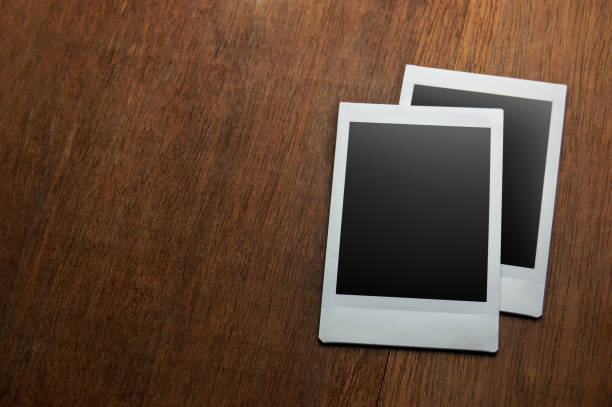 istock Instant photo frame on wooden table 1007072930