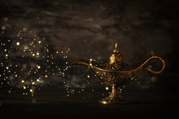 istock Image of magical mysterious aladdin lamp with glitter sparkle lights over black background. Lamp of wishes. 1007077204