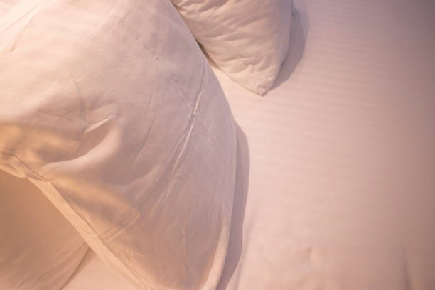 istock Modern minimalist luxury five star hotel bed cotton sheet and pillow case cover clean ready for guests. 1007080418