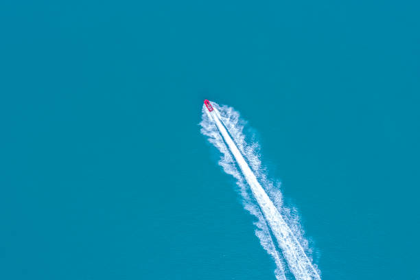 jetsky speeding on blue sea water jetsky speeding on blue sea water fast boat stock pictures, royalty-free photos & images