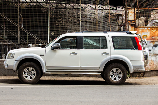Udaipur, India - 22 June 2018 : A white Ford Endeavour SUV  parked outside a garage for repairing and paint purpose