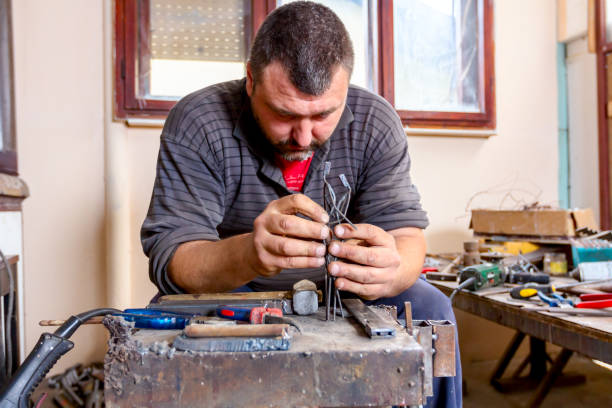 istock Artist is correcting figurine's posture with his bare hands 1007090322