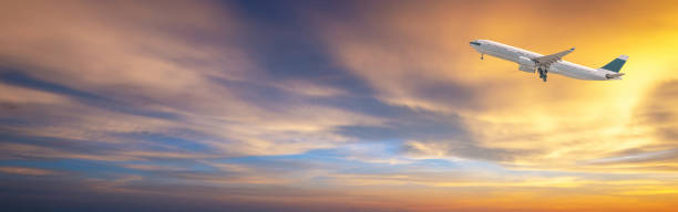 istock Commercial airplane flying over bright blue sky and white clouds 1007090456