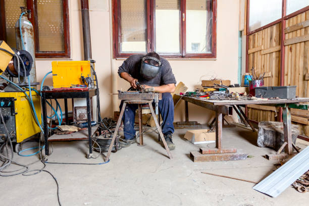 istock Artist is making figure by welding few metal wires in his workshop, barehande 1007090818