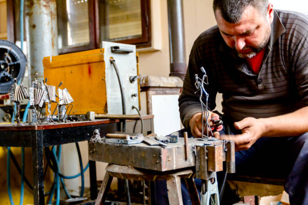 istock Craftsman is making figure with metal wire in his workshop 1007091424