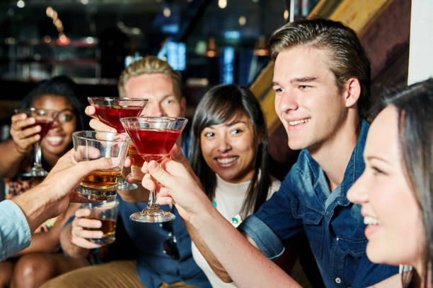 istock Group of happy young adults drinking in a bar 1007094540