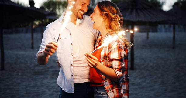 istock Group of happy friends having fun on beach at night 1007097722