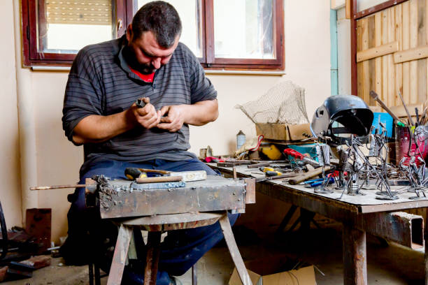 istock Craftsman is making figure with metal wire in his workshop 1007097764