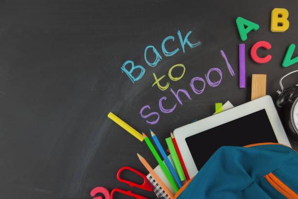 istock Back to school Accessories for school on a dark background Pencils Plasticine letters Letters Alarm clock Briefcase Chalk Copy space Top view 1007097842