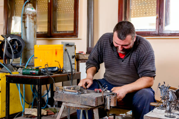 istock Craftsman is making figure with metal wire in his workshop. 1007098202