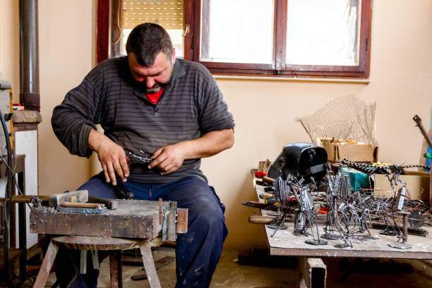 istock Craftsman is making figure with metal wire in his workshop. 1007098394