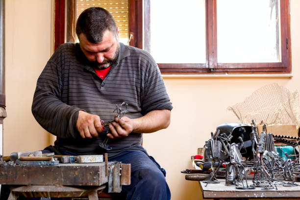 istock Craftsman is making figure with metal wire in his workshop. 1007098586