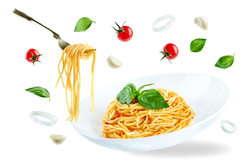 Flying Pasta with Marinara sauce and fresh Basil isolated. toning. selective focus
