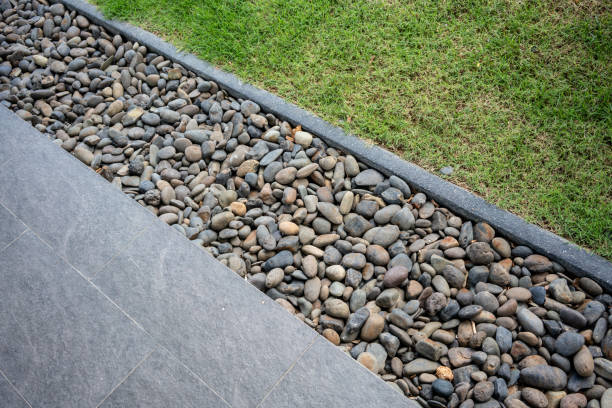 istock Dark grey stone decorated along with black granite tile floor and lawn for public space. Landscape design detail. 1007098802