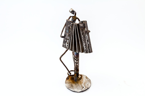Figure of music performer made with welded black metal wire, accordionist is playing solo with accordion, living lines.