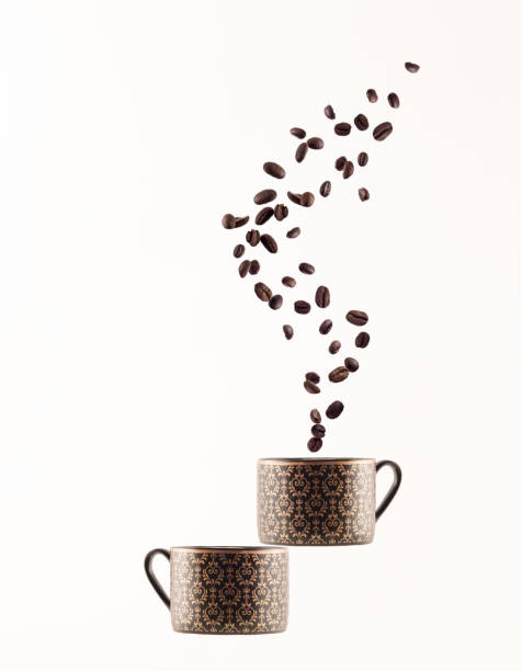 istock Coffee beans in shape of steam above two coffee cups 1007101314