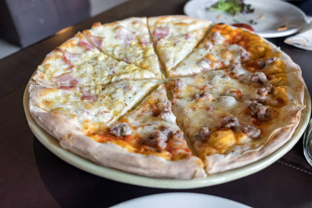 istock Pizza homemade fresh carbonara ham half Italian sausage on table 1007101672