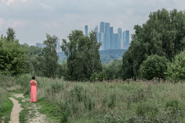 A middle-aged woman in a pink dress