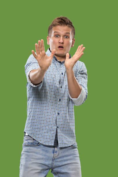 istock Portrait of the scared man on green 1007105300