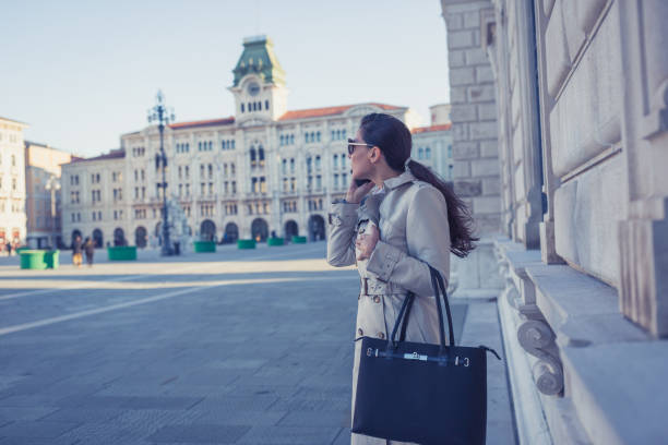 istock Businesswoman walking to the office, using mobile phone 1007120596