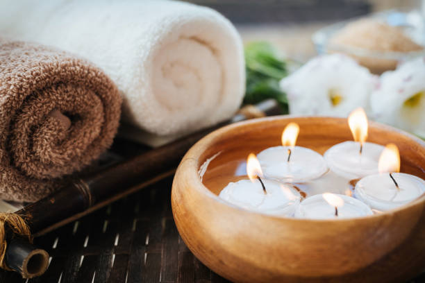 Burning candles in water. Composition of spa. stock photo