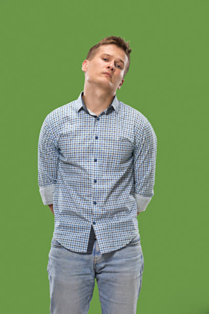 istock Beautiful bored man bored isolated on green background 1007129960