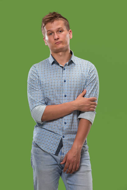 istock Beautiful bored man bored isolated on green background 1007130076