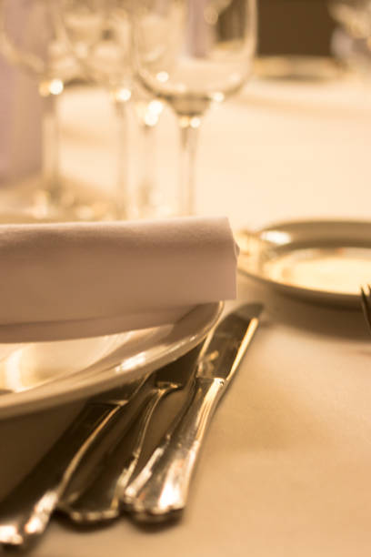 istock Wedding reception banquet dinner party table place settings set in luxury hotel venue. 1007144014