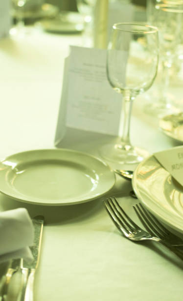 istock Wedding reception banquet dinner party table place settings set in luxury hotel venue. 1007144032