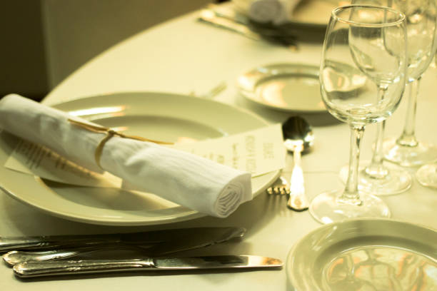istock Wedding reception banquet dinner party table place settings set in luxury hotel venue. 1007144212