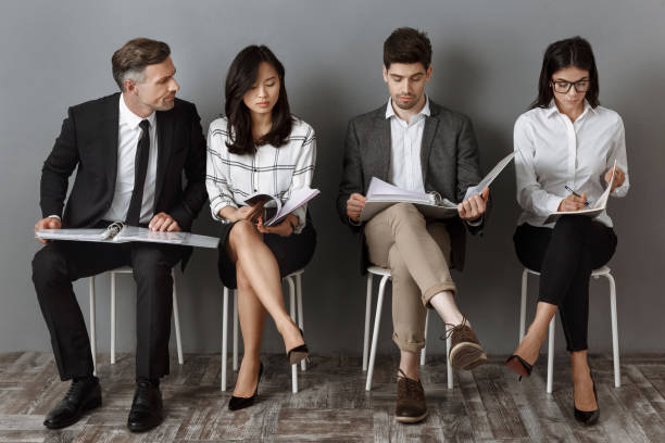 istock multicultural business people with folders and notebooks waiting for job interview 1007144218