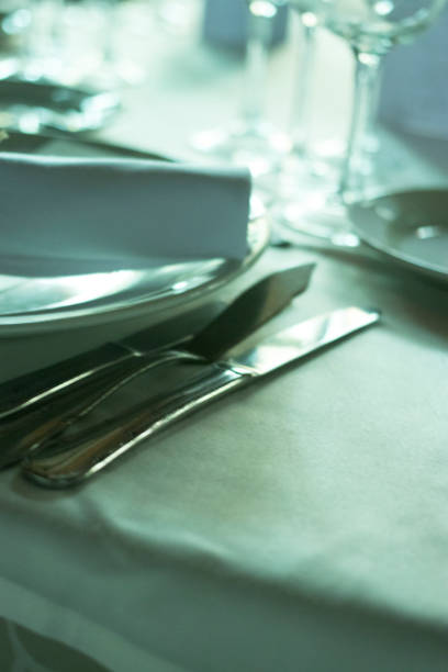 istock Wedding reception banquet dinner party table place settings set in luxury hotel venue. 1007144294