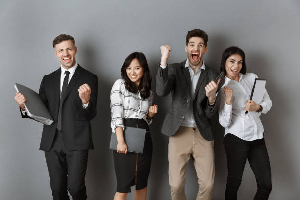 istock happy multicultural business people with folders and notebooks standing at grey wall 1007144794