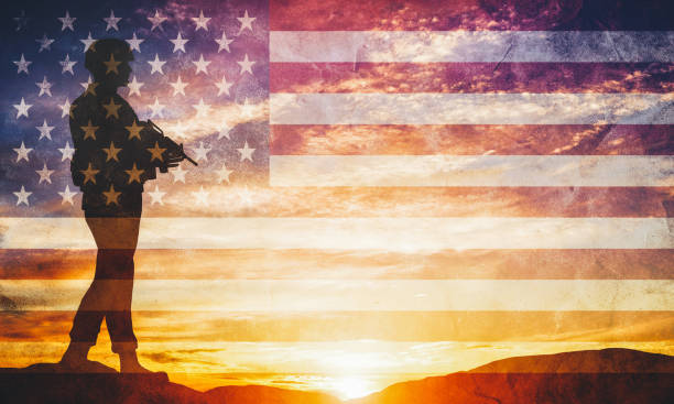 Armed soldier with rifle and USA flag. Guard, army, military, war. Armed soldier with rifle standing and looking on horizon. USA flag. Silhouette at sunset. War, army, military, guard. afghanistan army stock pictures, royalty-free photos & images